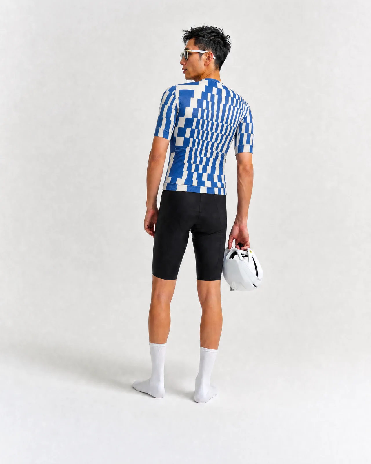 Jersey, pixelated blue and cream pattern, rear view, worn with black bib shorts